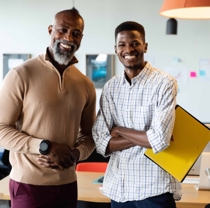 Portrait of smiling african american businessmen in creative office. Unaltered, creative business, workplace, occupation, teamwork, positive emotion.